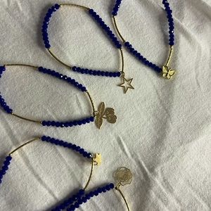 5 bracelets with different symbols